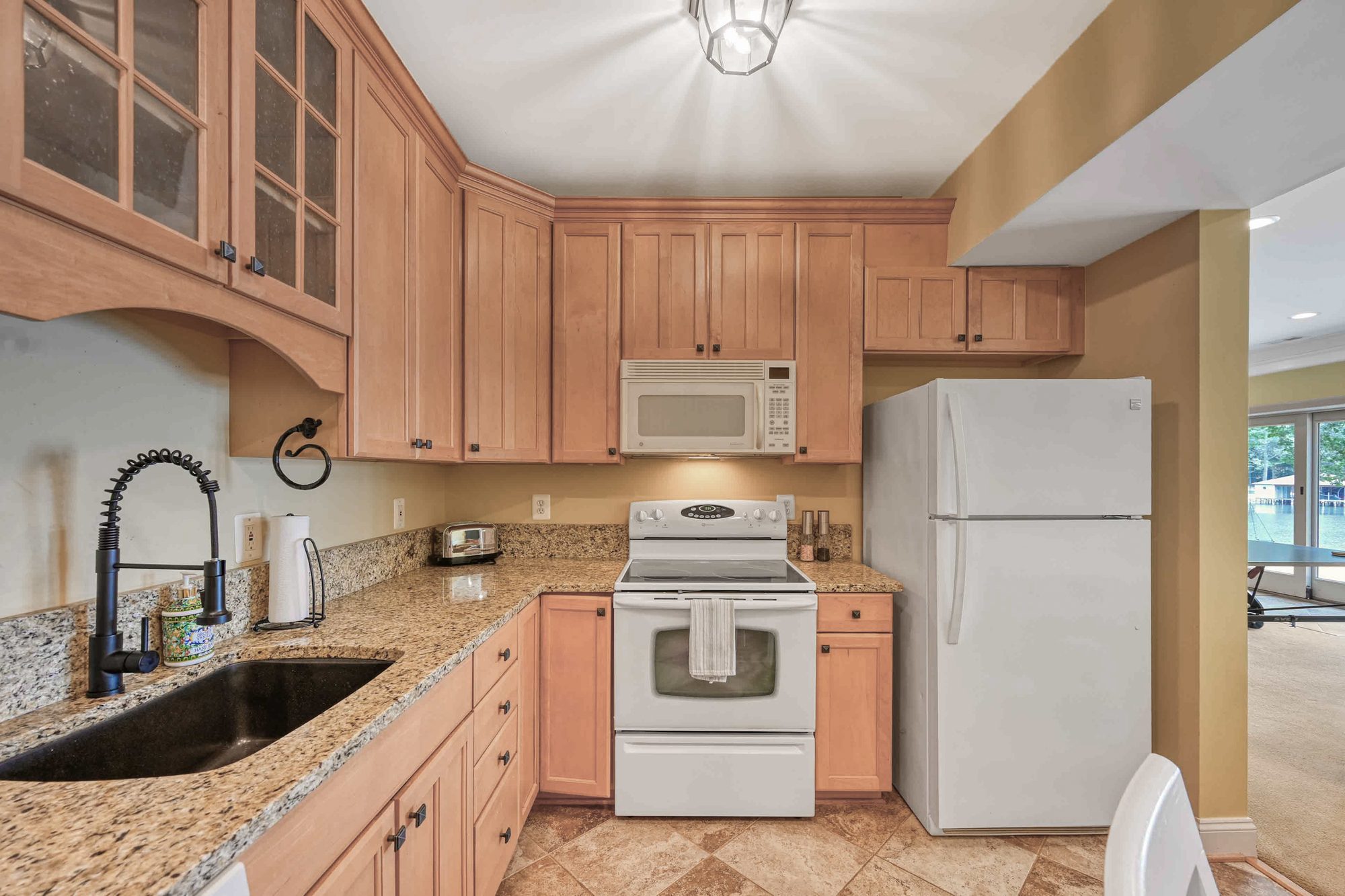 Lower-level second kitchen with fridge, range and sink